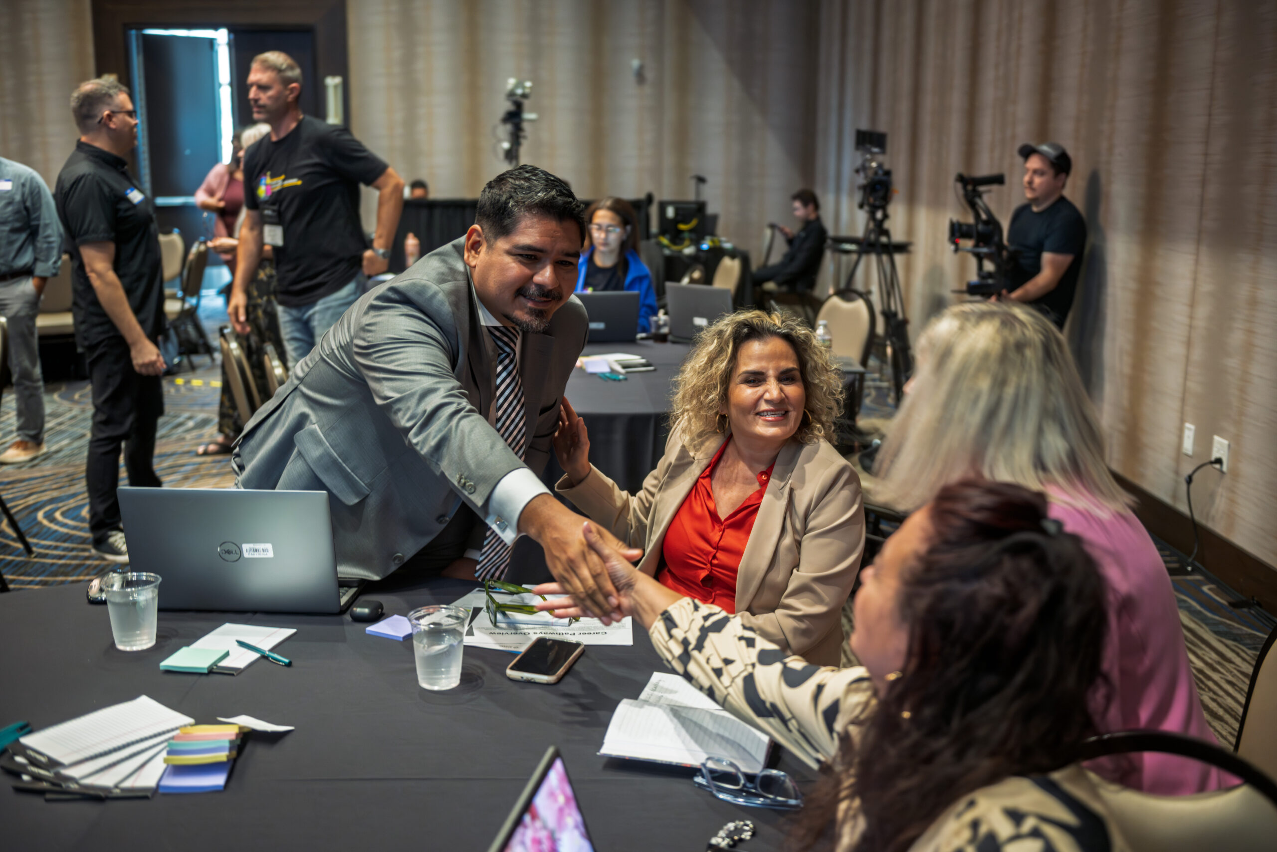Handshake across a conference table at the Career Pathways Symposium