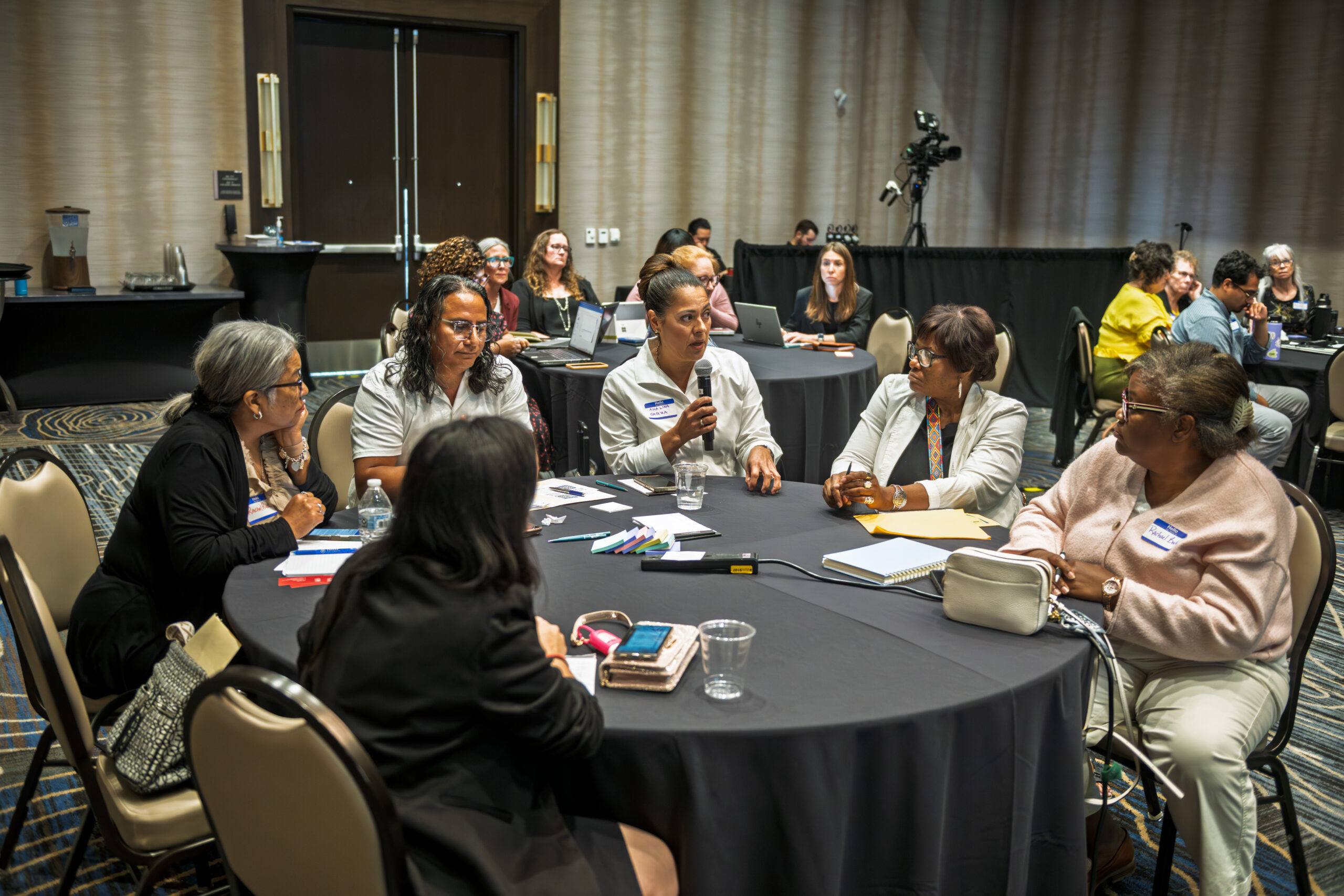 Career Pathways Symposium attendees engaged at round tables during a session