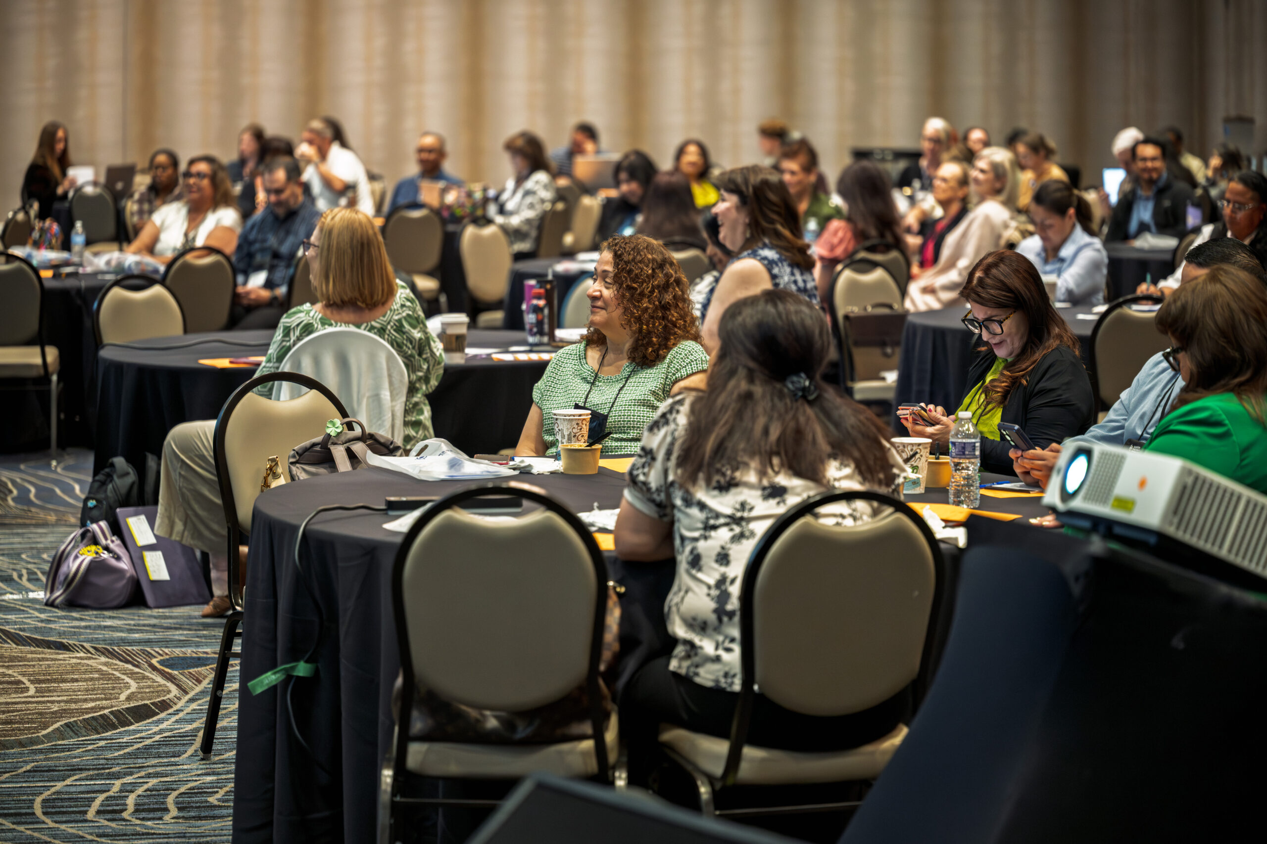 Career Pathways Symposium attendees engaged at round tables during a session