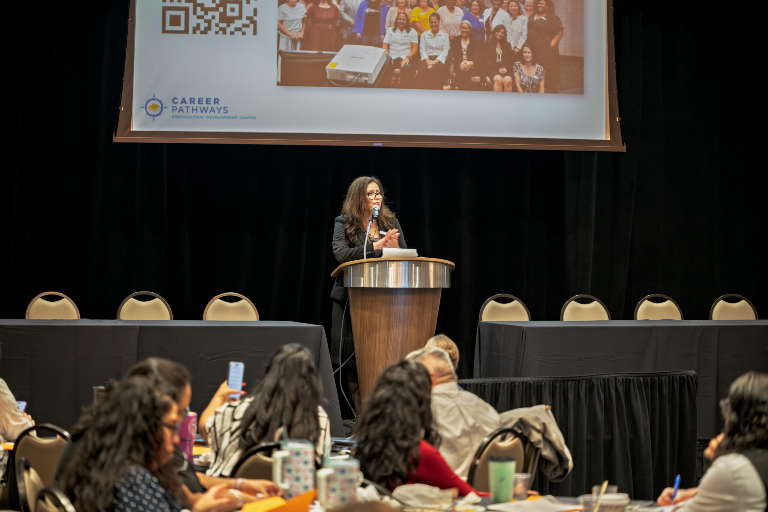 Speaker at the podium addressing attendees at the Career Pathways Symposium